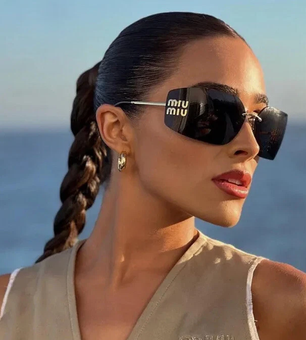 Female model wearing Miu Miu sunglasses available at THE OPTICAL in Limassol