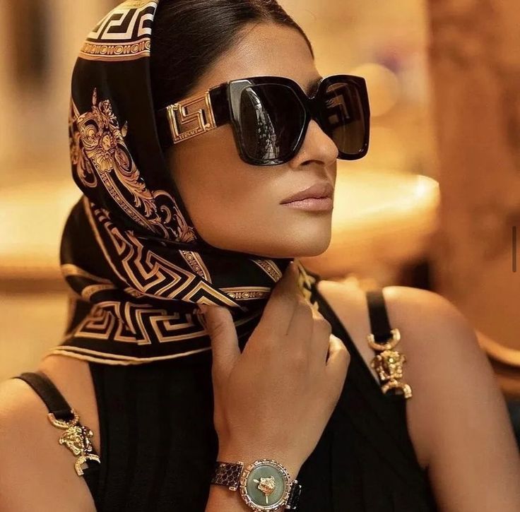 Female model wearing luxury Versace sunglasses.